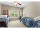 Inviting bedroom with twin beds, ceiling fan, and natural light offering a relaxing space at 208 Greenhill Dr, Dallas, GA 30157