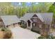 Well-maintained home with lush landscaping, gray roof, and a spacious driveway leading to the garage at 208 Greenhill Dr, Dallas, GA 30157