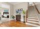 Charming foyer featuring hardwood floors, staircase, and view of the bedroom at 208 Greenhill Dr, Dallas, GA 30157