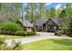 Charming craftsman-style home boasts meticulous landscaping, a circular driveway, and a striking blue front door at 208 Greenhill Dr, Dallas, GA 30157
