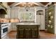 Gourmet kitchen with island, granite countertops, stainless steel appliances, and custom cabinetry at 208 Greenhill Dr, Dallas, GA 30157