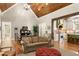 Cozy living room with vaulted ceilings, wood beams, and access to the kitchen at 208 Greenhill Dr, Dallas, GA 30157
