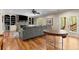 Spacious living room with stone fireplace, built-in shelves, hardwood floors, and access to the outdoors at 208 Greenhill Dr, Dallas, GA 30157