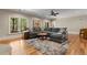 Open living room with a large sectional sofa, hardwood floors, and scenic views from the windows at 208 Greenhill Dr, Dallas, GA 30157