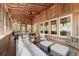 Inviting sunroom featuring wood paneling, string lights, ceiling fans, and comfortable seating area at 208 Greenhill Dr, Dallas, GA 30157