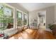 Bright sunroom with large windows offering natural light and views of the surrounding greenery at 208 Greenhill Dr, Dallas, GA 30157