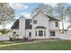 White two-story home featuring a lush backyard, patio, and well-maintained landscaping at 277 Edison Dr, Stockbridge, GA 30281