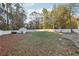 Large backyard with lush greenery, white fence, shed, and tree lined landscape at 277 Edison Dr, Stockbridge, GA 30281