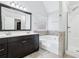 Bathroom featuring double vanity, a soaking tub, and a separate tiled shower at 277 Edison Dr, Stockbridge, GA 30281