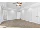 Bright, carpeted primary bedroom with a tray ceiling and ensuite bath access at 277 Edison Dr, Stockbridge, GA 30281