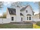 Rear exterior view of home, featuring white siding and stone patio at 277 Edison Dr, Stockbridge, GA 30281