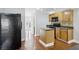 Functional kitchen featuring a kitchen island, black appliances, and wooden cabinets at 277 Edison Dr, Stockbridge, GA 30281