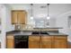 Kitchen with stainless steel sink, tile backsplash, modern faucet, and wood cabinets at 277 Edison Dr, Stockbridge, GA 30281