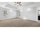 Bright main bedroom with a tray ceiling, ceiling fan, and plush carpeting at 277 Edison Dr, Stockbridge, GA 30281