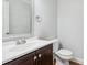Cozy powder room features modern fixtures, dark wood vanity, and a commode at 277 Edison Dr, Stockbridge, GA 30281