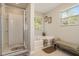 Bathroom with soaking tub, separate shower, and a bench by the window at 353 Daffodil Dr, Temple, GA 30179