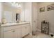 Bathroom with dual sinks, granite countertops, white cabinets, and a large mirror at 353 Daffodil Dr, Temple, GA 30179