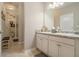 Bright bathroom featuring double sinks, granite countertops, white cabinets, and tile flooring at 353 Daffodil Dr, Temple, GA 30179