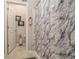 Bathroom with a shower featuring a marble shower curtain, white tiled floor, and white walls at 353 Daffodil Dr, Temple, GA 30179