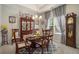 Elegant dining area with a classic wooden table set and refined furnishings at 353 Daffodil Dr, Temple, GA 30179