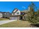 Attractive two-story home with a stone facade, a two-car garage and a neatly landscaped yard at 353 Daffodil Dr, Temple, GA 30179