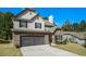 Charming two-story home featuring stone accents, a two-car garage and well-manicured landscaping at 353 Daffodil Dr, Temple, GA 30179