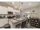 Bright kitchen features white cabinets, stainless steel appliances, granite countertops, and stylish pendant lighting at 353 Daffodil Dr, Temple, GA 30179