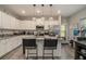 Bright kitchen featuring white cabinets, granite countertops, and stainless steel appliances at 353 Daffodil Dr, Temple, GA 30179