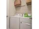Convenient laundry room with washer, dryer, and storage shelf, plus laundry detergent at 353 Daffodil Dr, Temple, GA 30179