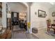 Open-concept living space with hardwood floors, archways, and a glimpse into the kitchen at 353 Daffodil Dr, Temple, GA 30179