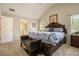 Bright main bedroom with a tray ceiling, a comfortable bed, and an ensuite bathroom at 353 Daffodil Dr, Temple, GA 30179