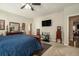Comfortable main bedroom with a plush bed, dresser, television, and ensuite bathroom at 353 Daffodil Dr, Temple, GA 30179