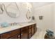 Bathroom featuring double sinks, marble countertops, designer mirrors and tile floors at 405 Ballymore Pass, Woodstock, GA 30189
