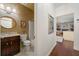 Well-lit bathroom featuring a modern vanity with a round mirror and a glass-enclosed shower at 405 Ballymore Pass, Woodstock, GA 30189
