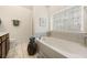 Relaxing bathroom with a soaking tub and a large window for natural light at 405 Ballymore Pass, Woodstock, GA 30189