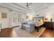 Beautiful bedroom with a tray ceiling, sitting area, and natural light from a large window at 405 Ballymore Pass, Woodstock, GA 30189