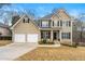 Charming two-story home featuring a two-car garage and well-maintained landscaping at 405 Ballymore Pass, Woodstock, GA 30189
