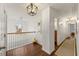 Upstairs hallway with wooden floors, white banisters and access to other rooms at 405 Ballymore Pass, Woodstock, GA 30189