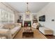 Elegant living room featuring a fireplace, large windows, and comfortable seating at 405 Ballymore Pass, Woodstock, GA 30189