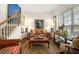 Comfortable living room with plush seating, a staircase, and natural light at 405 Ballymore Pass, Woodstock, GA 30189
