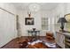 Sitting room featuring a cowhide rug, a round table with an elaborate chandelier above at 405 Ballymore Pass, Woodstock, GA 30189
