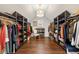 Spacious walk-in closet with custom shelving, hardwood floors, and a stylish light fixture at 405 Ballymore Pass, Woodstock, GA 30189