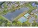 Beautiful aerial view of a community featuring a pond, pool, tennis courts, and well-maintained landscaping at 4461 Kentland Dr, Acworth, GA 30101