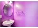 Powder room with purple walls, updated vanity and mirror at 4461 Kentland Dr, Acworth, GA 30101