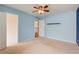 A bedroom with pale blue walls, carpet, ceiling fan, and a closet at 4461 Kentland Dr, Acworth, GA 30101