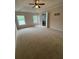 Spacious bedroom featuring a ceiling fan, two windows, and access to the ensuite bathroom at 4461 Kentland Dr, Acworth, GA 30101