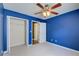 A bedroom features plush carpet, a ceiling fan, and a closet with a white door at 4461 Kentland Dr, Acworth, GA 30101