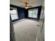 A spacious bedroom with neutral carpet, two windows, and a ceiling fan at 4461 Kentland Dr, Acworth, GA 30101