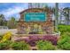 Stone community entrance sign for Huddlestone Bridge with flower beds at 4461 Kentland Dr, Acworth, GA 30101