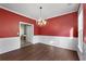 Spacious dining room featuring hardwood floors, white trim, and a stylish chandelier at 4461 Kentland Dr, Acworth, GA 30101